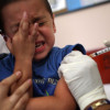 HIALEAH, FL - AUGUST 08:  Michael Valdivia holds, Jakob Gutierrez, 5, as he receives an immunization shot from school nurse Barbara Dale on August 8, 2007 in Hialeah, Florida. The free immunization is part of the Miami-Dade County Health Department's program to help children heading back to school.  (Photo by Joe Raedle/Getty Images)